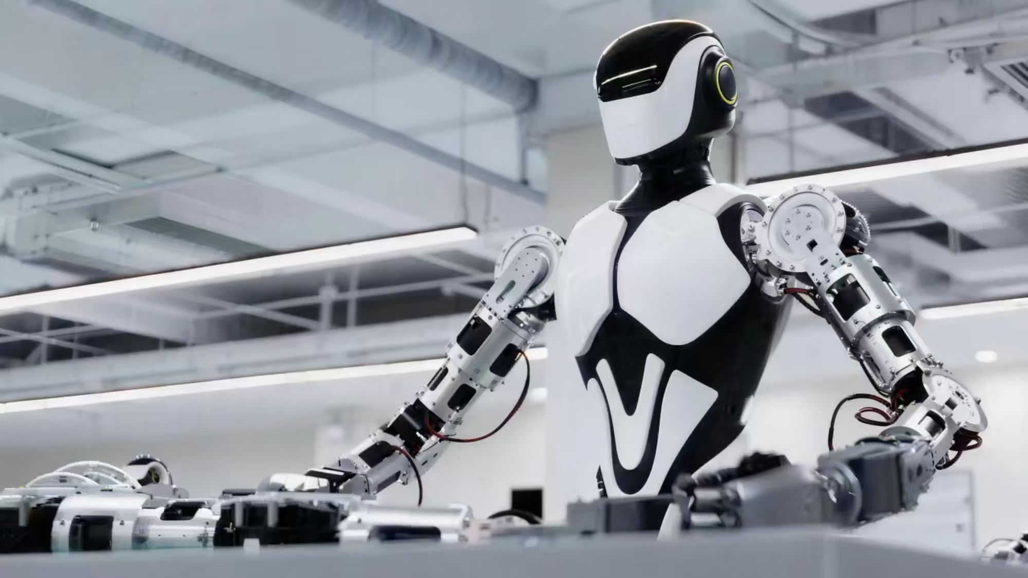 Humanoid robot working at an automation workstation in a bright lab